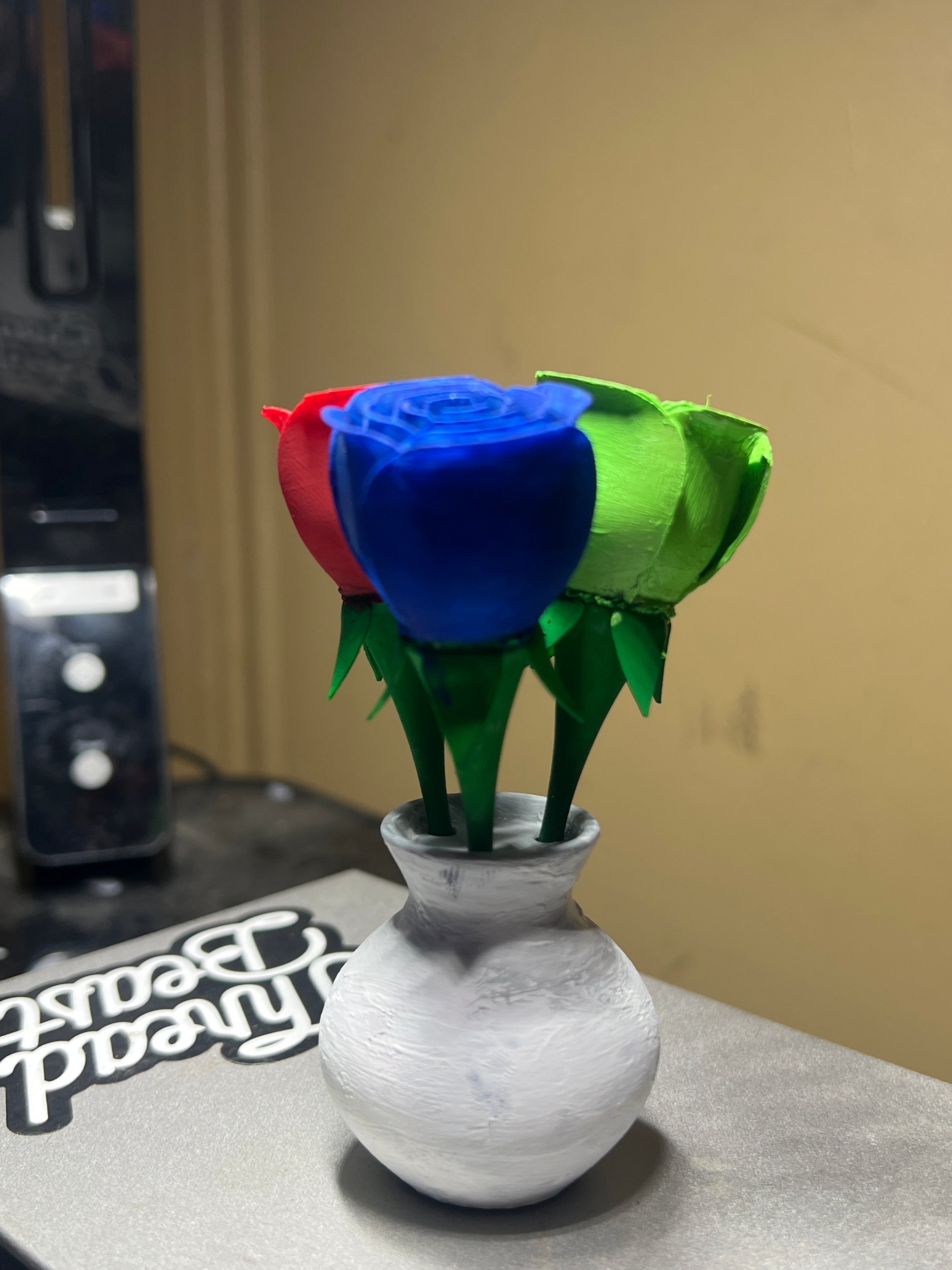 3 painted roses in a vase