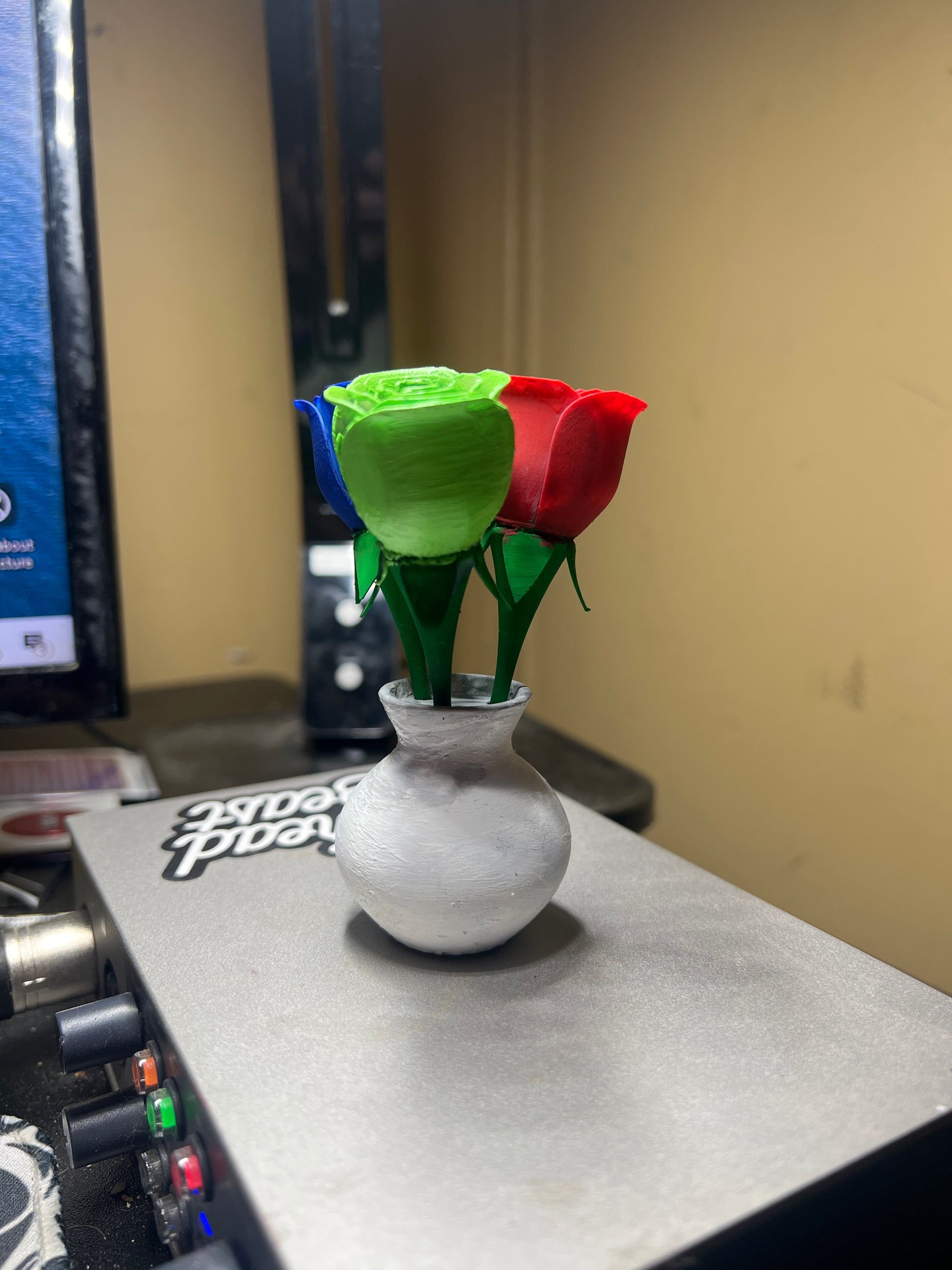 3 painted roses in a vase
